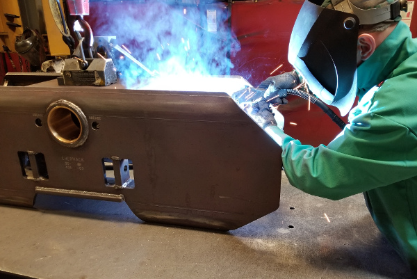 Person Welding a Track System